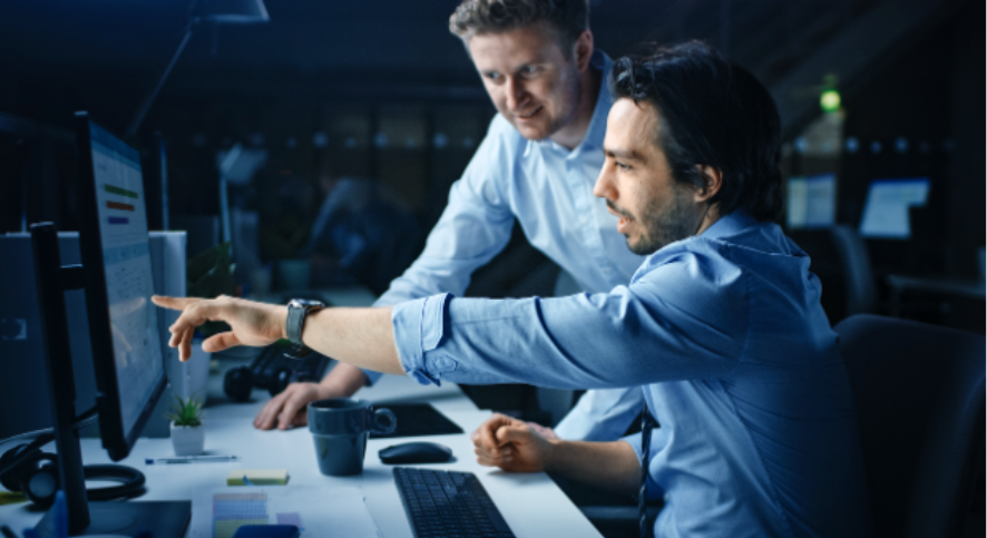 Businessmen looking at monitor